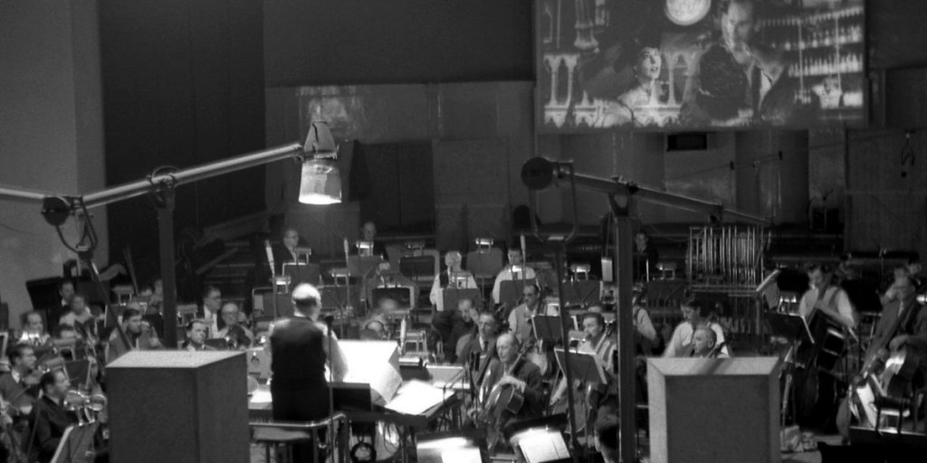 Dimitri-Tiomkin-and-orchestra-55-Days-at-Peking.jpg